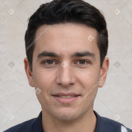 Joyful white young-adult male with short  black hair and brown eyes