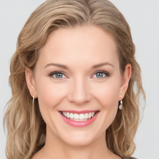 Joyful white young-adult female with medium  brown hair and blue eyes