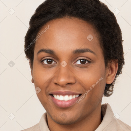 Joyful black young-adult female with short  brown hair and brown eyes