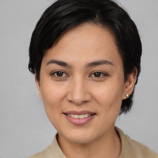 Joyful asian young-adult female with medium  brown hair and brown eyes