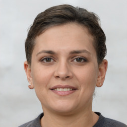 Joyful white young-adult female with short  brown hair and brown eyes