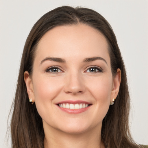 Joyful white young-adult female with long  brown hair and grey eyes