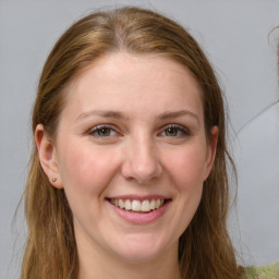 Joyful white young-adult female with long  brown hair and blue eyes