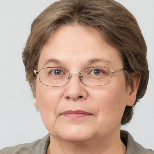 Joyful white middle-aged female with medium  brown hair and grey eyes