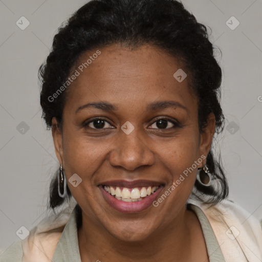 Joyful black adult female with short  brown hair and brown eyes