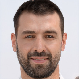 Joyful white adult male with short  brown hair and brown eyes