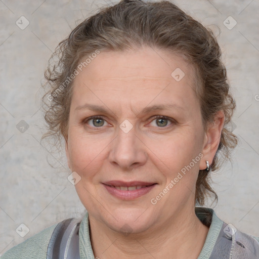 Joyful white adult female with medium  brown hair and blue eyes