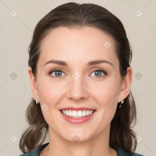 Joyful white young-adult female with medium  brown hair and grey eyes