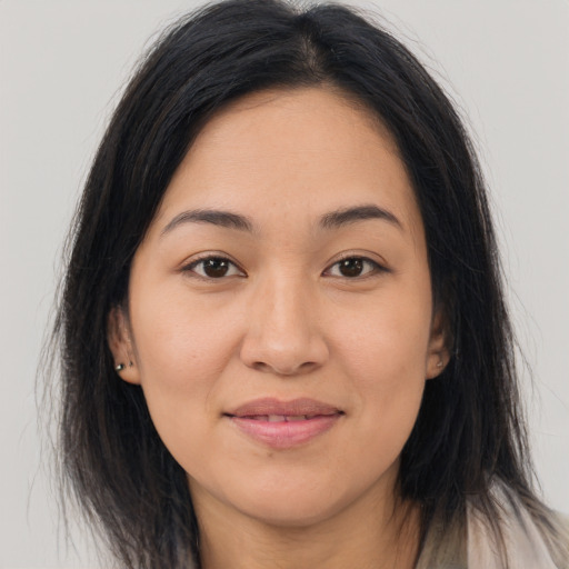 Joyful asian young-adult female with long  brown hair and brown eyes
