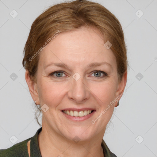 Joyful white adult female with medium  brown hair and grey eyes