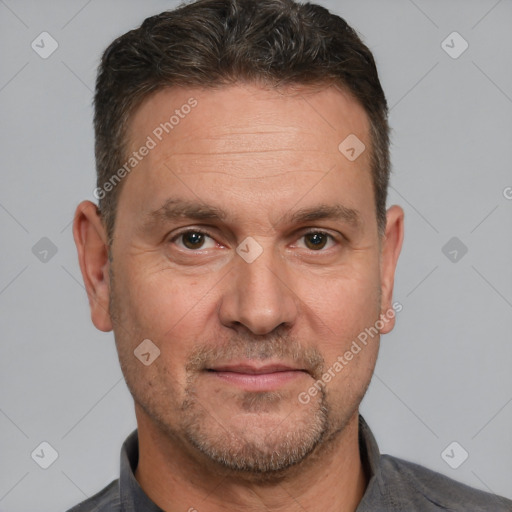 Joyful white adult male with short  brown hair and brown eyes