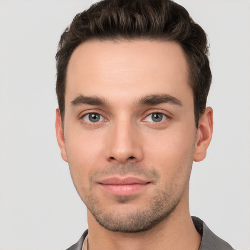 Joyful white young-adult male with short  brown hair and brown eyes