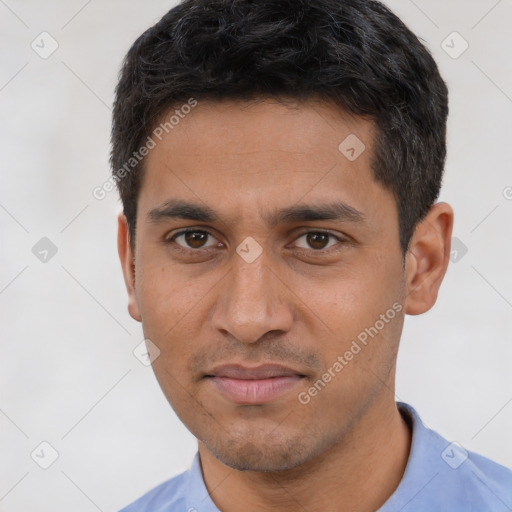 Joyful white young-adult male with short  black hair and brown eyes