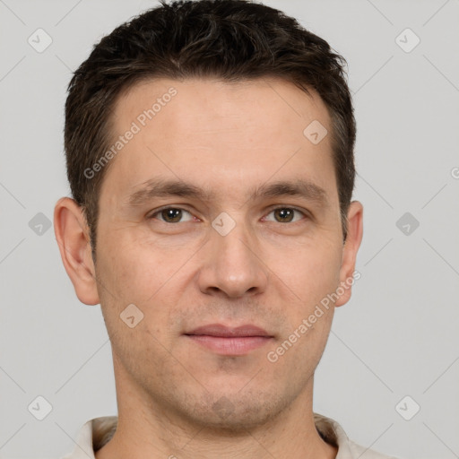 Joyful white young-adult male with short  brown hair and grey eyes