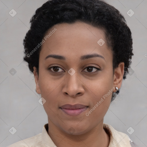 Joyful black young-adult female with short  black hair and brown eyes