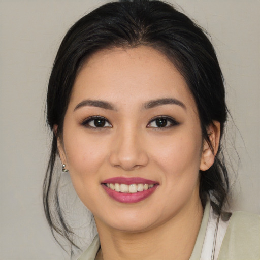 Joyful asian young-adult female with medium  brown hair and brown eyes