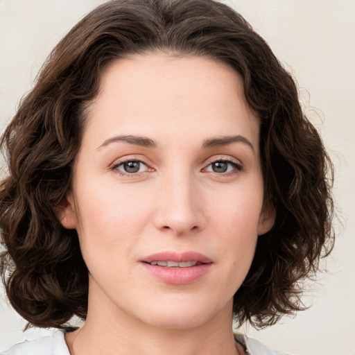 Joyful white young-adult female with medium  brown hair and green eyes