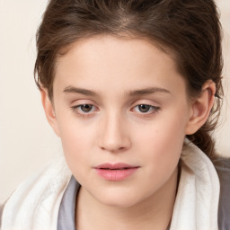 Joyful white child female with long  brown hair and brown eyes