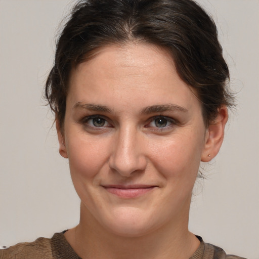 Joyful white young-adult female with medium  brown hair and brown eyes