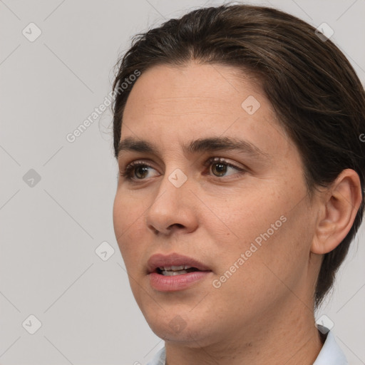 Joyful white adult female with medium  brown hair and brown eyes