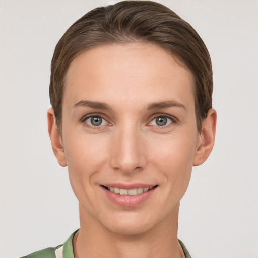 Joyful white young-adult female with short  brown hair and grey eyes