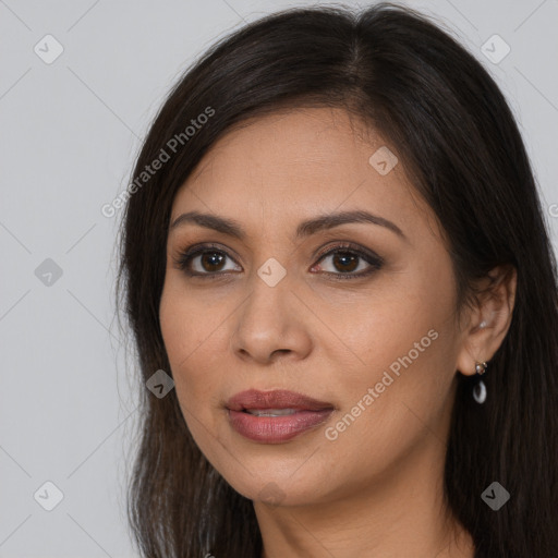 Joyful latino young-adult female with long  brown hair and brown eyes