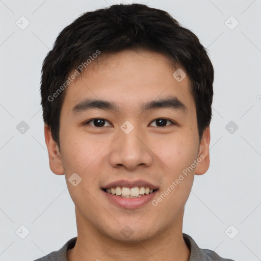 Joyful white young-adult male with short  black hair and brown eyes