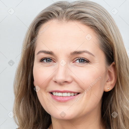 Joyful white young-adult female with long  brown hair and grey eyes