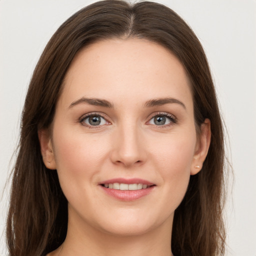 Joyful white young-adult female with long  brown hair and grey eyes