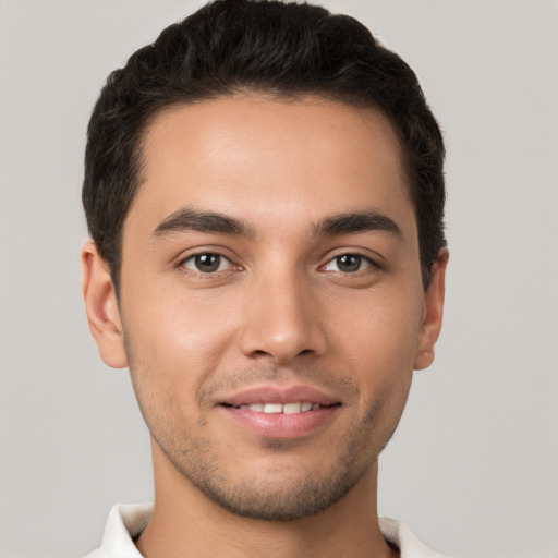 Joyful white young-adult male with short  brown hair and brown eyes