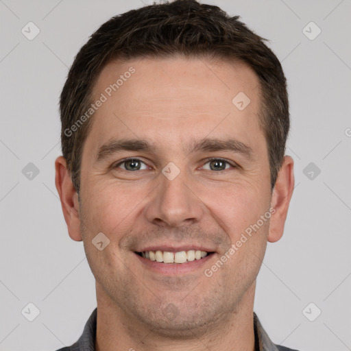 Joyful white adult male with short  brown hair and grey eyes