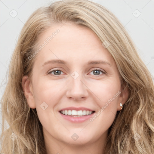 Joyful white young-adult female with long  brown hair and blue eyes