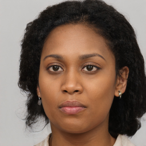 Neutral black young-adult female with long  brown hair and brown eyes