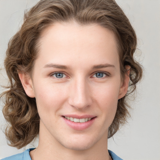 Joyful white young-adult female with medium  brown hair and blue eyes