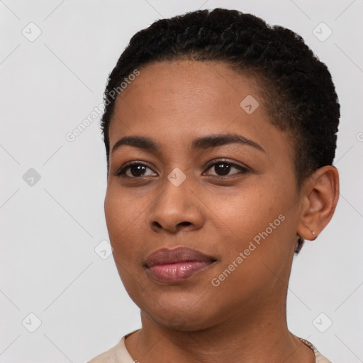 Joyful black young-adult female with short  black hair and brown eyes