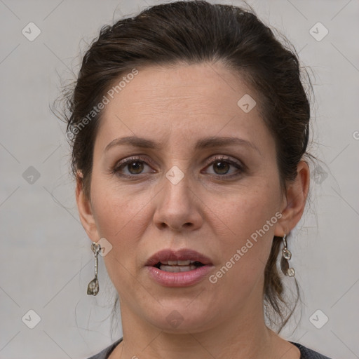 Joyful white adult female with medium  brown hair and grey eyes