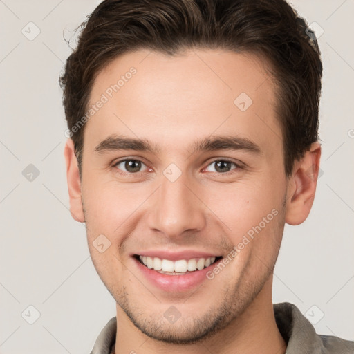 Joyful white young-adult male with short  brown hair and brown eyes