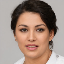 Joyful latino young-adult female with medium  brown hair and brown eyes