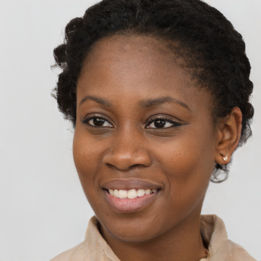 Joyful black young-adult female with medium  brown hair and brown eyes