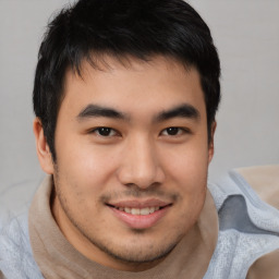 Joyful asian young-adult male with short  brown hair and brown eyes