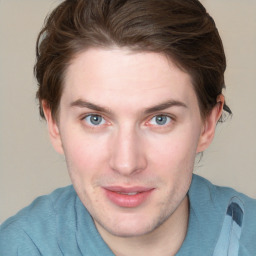 Joyful white young-adult male with short  brown hair and blue eyes