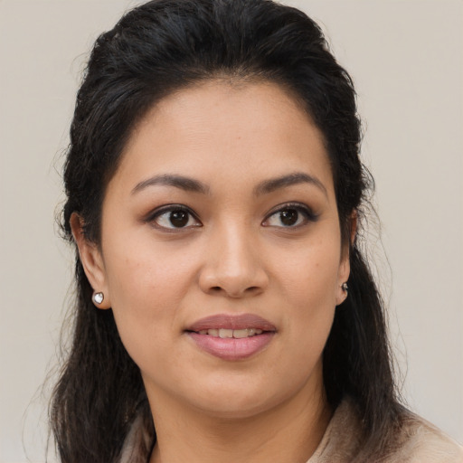 Joyful latino young-adult female with medium  brown hair and brown eyes