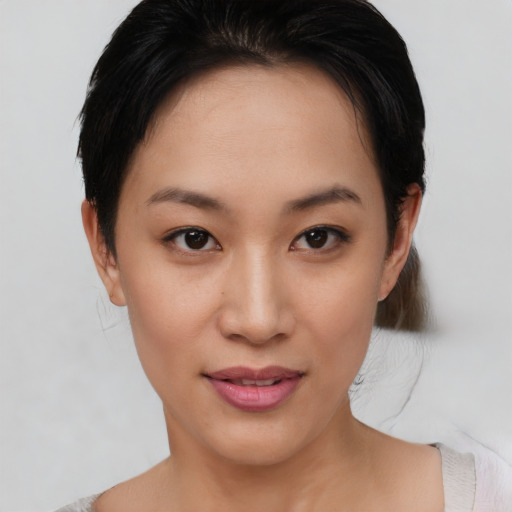 Joyful asian young-adult female with short  brown hair and brown eyes