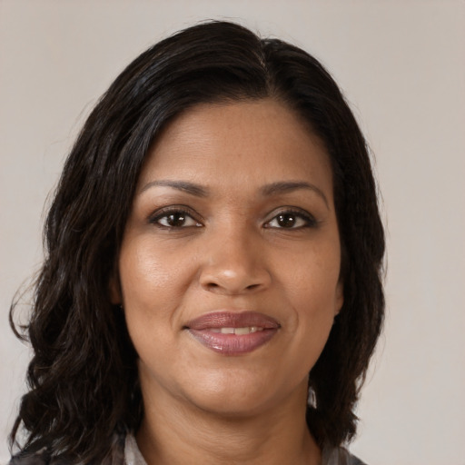 Joyful black young-adult female with medium  brown hair and brown eyes