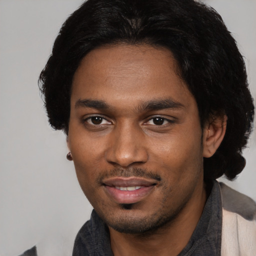 Joyful black young-adult male with short  black hair and brown eyes