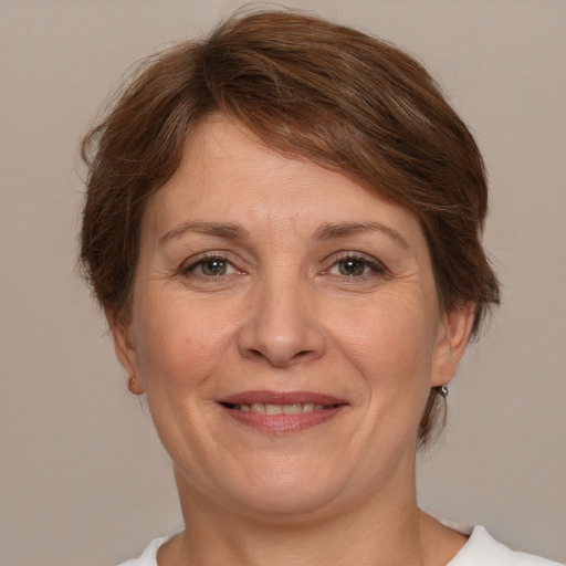 Joyful white adult female with medium  brown hair and brown eyes