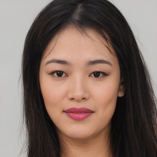 Joyful asian young-adult female with long  brown hair and brown eyes
