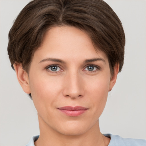 Joyful white young-adult female with short  brown hair and grey eyes