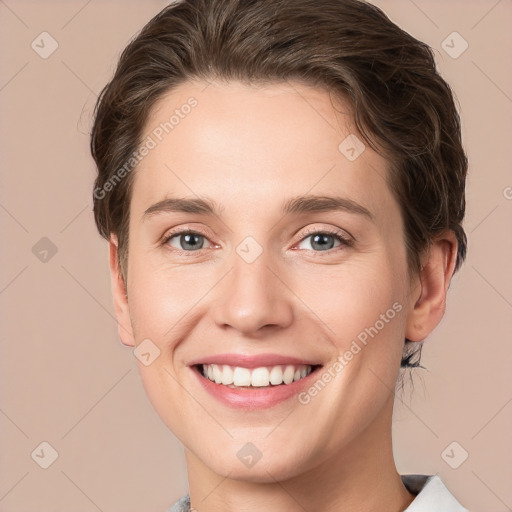 Joyful white young-adult female with short  brown hair and grey eyes