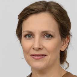 Joyful white adult female with medium  brown hair and grey eyes